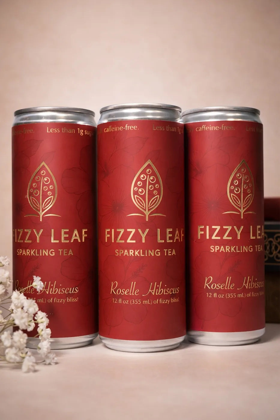 Three cans of Fizzy Leaf Roselle Hibiscus Sparkling Tea